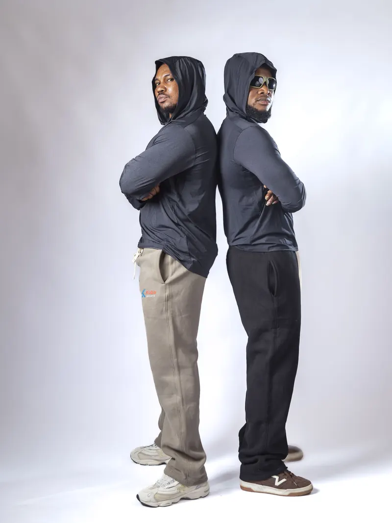 Two athletes standing back to back in KUBA SPORTS hooded training tops